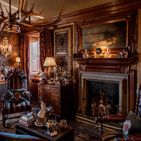 Ornate wood panelling and antique furnishings in the Owners Suite at Prestonfield House 5 Star Edinburgh hotel