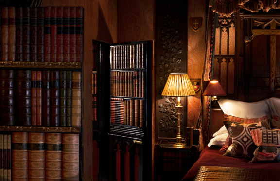 The Library suite with rich wood panelling and antique furnishings
