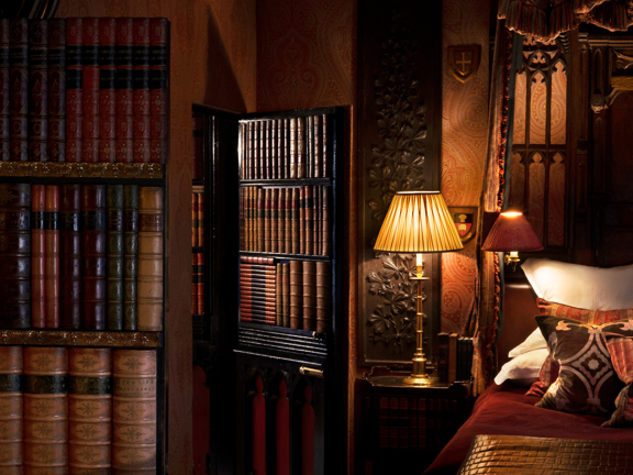 The Library suite with rich wood panelling and antique furnishings