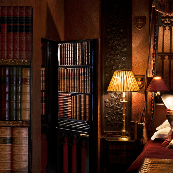 The Library suite with rich wood panelling and antique furnishings