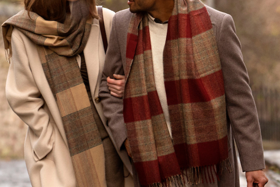 Couple walking down cobbled streets on a staycation in Edinburgh