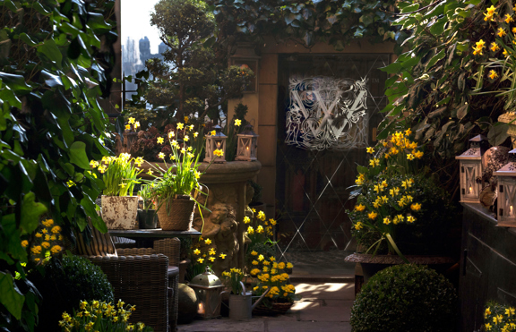 The Secret Garden at the Witchery in Spring with flowers and an entrance to the restaurant