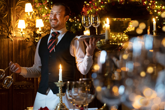Waiter serving wine during Christmas