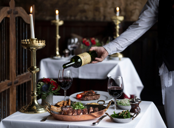 Intimate table setting beneath a gilded ceiling in Edinburgh’s most atmospheric restaurant