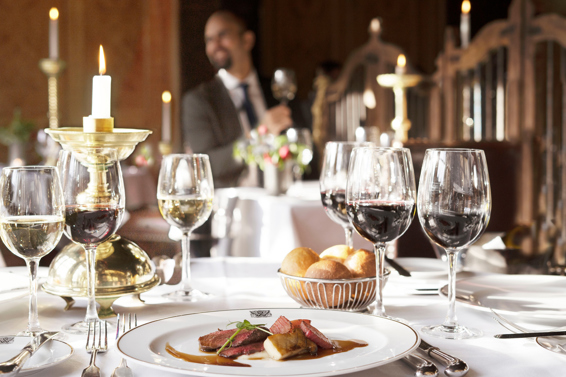 Plate of food and glasses of wine at The Witchery