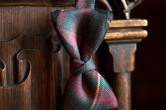 Tartan bow tie handing on ornate chair in a luxury suite